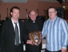 Canon Murphy presents the Mc Killop Family Shield for Juvenile team of the year to Minor Hurling Managers Michael Hardy and Tony O'Kane 